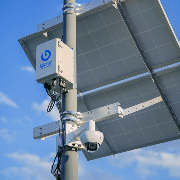 Gridless solar remote sentry security setup against blue sky background with dome camera.