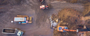 Worksite with excavators, portable office, and large truck